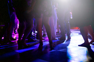 People Dancing on a block shaped dance floor at night outdoors